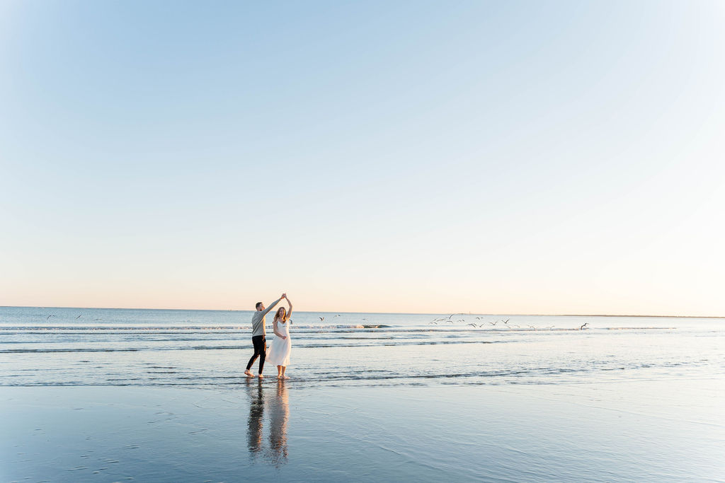 Wide scenic engagement photo of Caroline and Jamie on Sullivan’s Island beach
